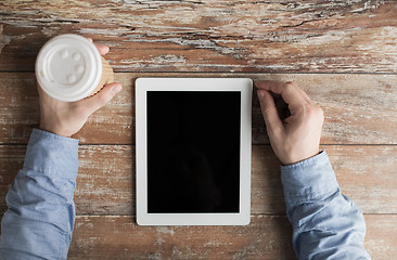 Image showing close up of male hands with tablet pc and coffee