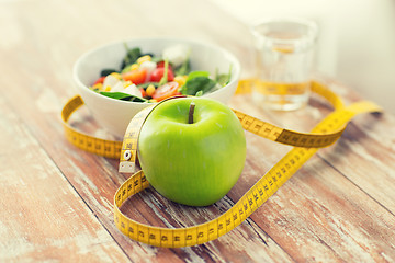 Image showing close up of green apple and measuring tape