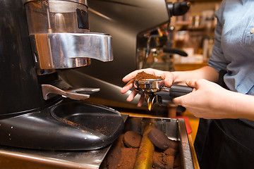 Image showing close up of woman making coffee by machine at cafe