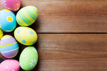 Image showing close up of colored easter eggs on wooden surface