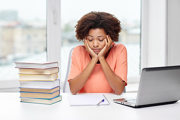 Image showing bored african american woman doing homework home