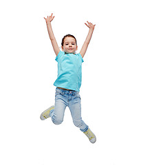 Image showing happy little girl jumping in air