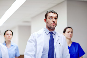 Image showing group of medics walking along hospital