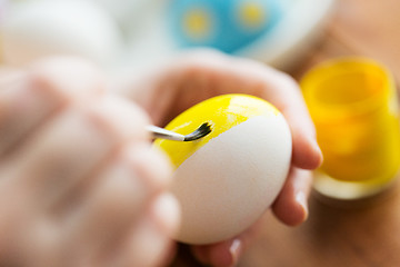 Image showing close up of woman hands coloring easter eggs