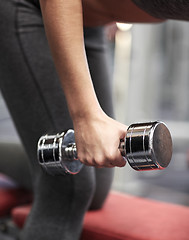 Image showing close up of couple with dumbbell exercising in gym