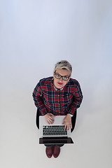 Image showing top view of young business woman working on laptop computer