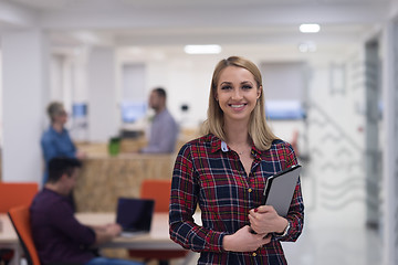 Image showing portrait of young business woman at office with team in backgrou