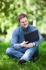 Image showing Businessman working in the park.