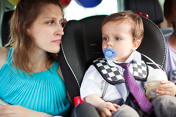 Image showing Mom looking at her son in child safety seat