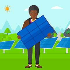 Image showing Man holding solar panel.