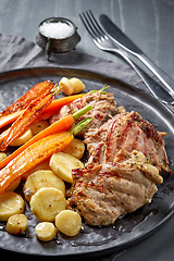 Image showing chicken meat and roasted vegetables on gray plate