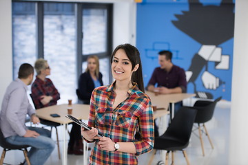 Image showing portrait of young business woman at office with team in backgrou