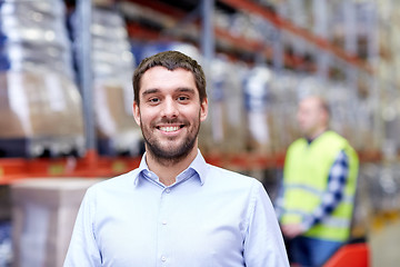 Image showing businessman over warehouse loader on forklift 
