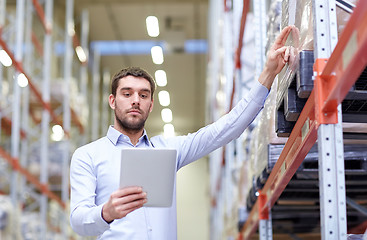 Image showing businessman with tablet pc at warehouse