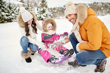 Image showing happy family with kid on sled having fun outdoors
