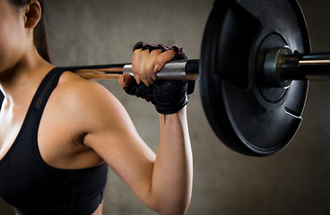 Image showing close up of woman with barbell in gym