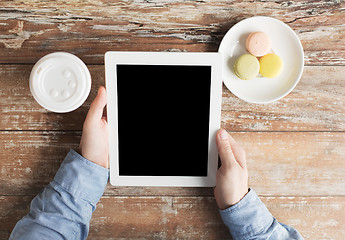 Image showing close up of male hands with tablet pc and coffee