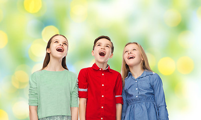 Image showing amazed boy and girls looking up