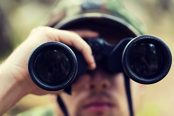 Image showing close up of soldier or hunter with binocular