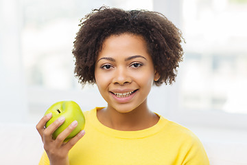 Image showing happy african american woman with green apple