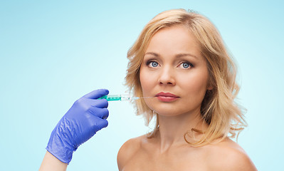 Image showing woman face and beautician hand with syringe