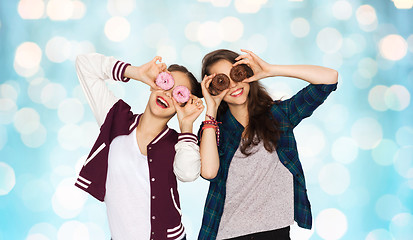 Image showing happy pretty teenage girls with donuts having fun