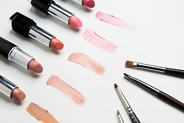 Image showing close up of lipsticks range with makeup brushes