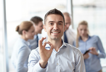 Image showing group of smiling businesspeople meeting in office