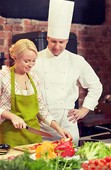 Image showing happy male chef cook with woman cooking in kitchen