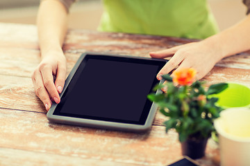 Image showing close up of woman or gardener with tablet pc
