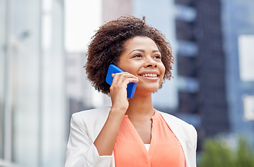 Image showing happy african businesswoman calling on smartphone