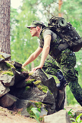 Image showing young soldier with backpack in forest