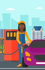 Image showing Woman filling up fuel into car.