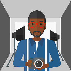 Image showing Smiling photographer holding camera.