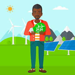 Image showing Man holding lightbulb with windmills inside.