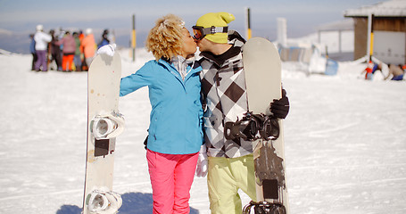 Image showing Romantic young couple enjoying a public kiss