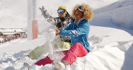 Image showing Young couple playing in the snow at a ski resort