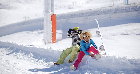 Image showing Young couple getting ready to go snowboarding