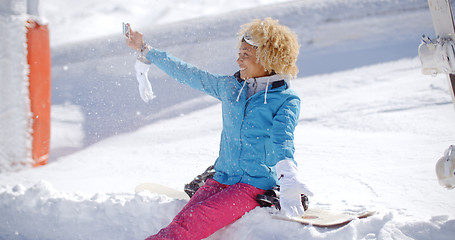 Image showing Happy young woman posing for a winter selfie