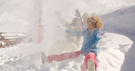 Image showing Young couple playing in the snow at a ski resort