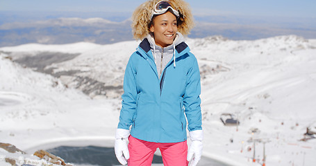 Image showing Beautiful woman in ski outfit standing on mountain