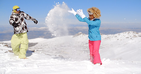 Image showing Couple in snowsuits playing the snow