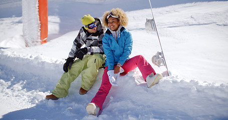 Image showing Happy young couple relaxing on a snow shelf