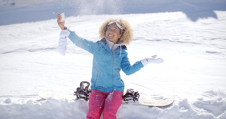 Image showing Playful woman posing for a selfie in the snow