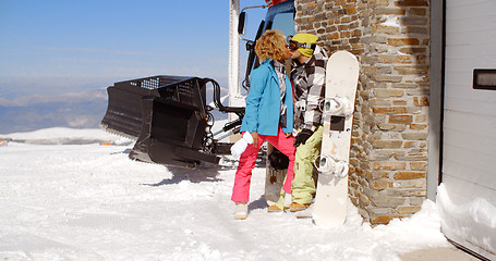 Image showing Couple kissing behind ski resort garage