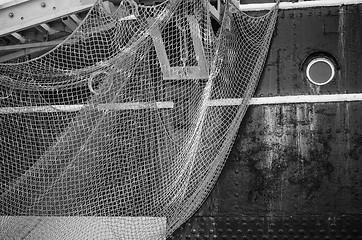 Image showing Window of the ship and hanging down networks, close up