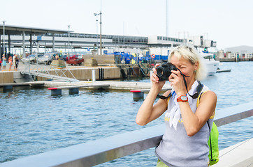 Image showing Woman photographs on the quay