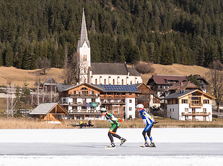 Image showing Two people skating on the ice