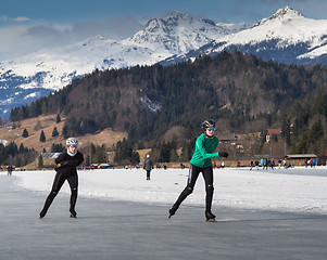 Image showing Two people skating on the ice
