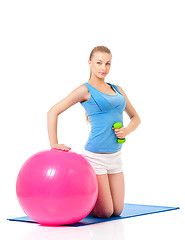 Image showing Woman in fitness wear exercising with fitness-ball